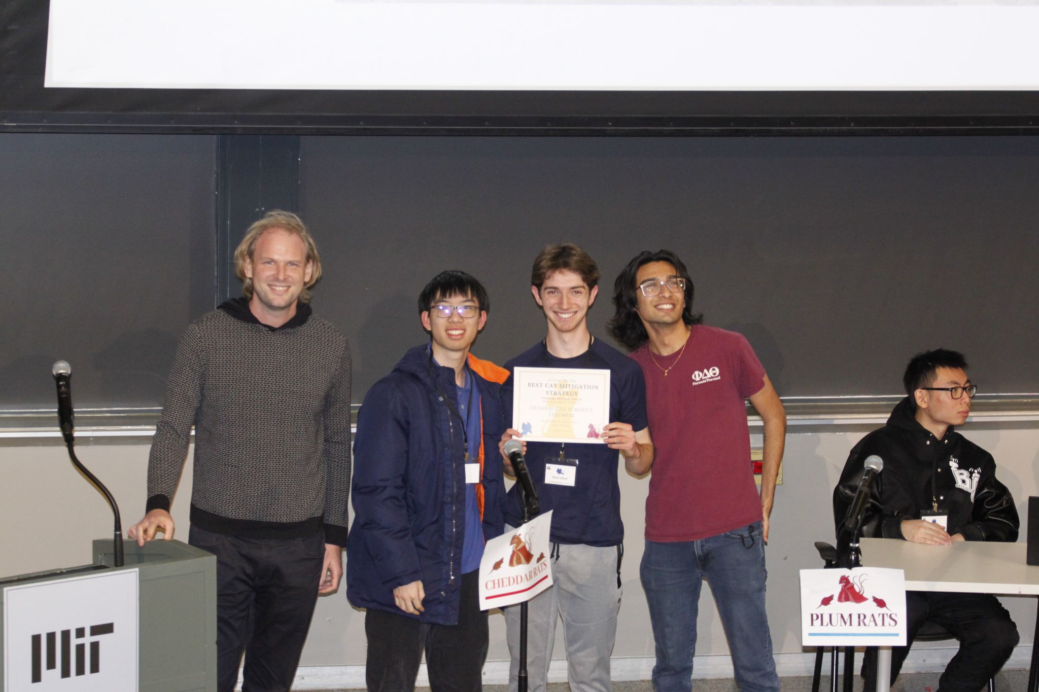 Battlecode team holding an award certificate at MIT